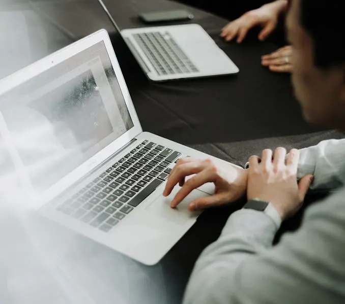 A person uses the trackpad on their laptop